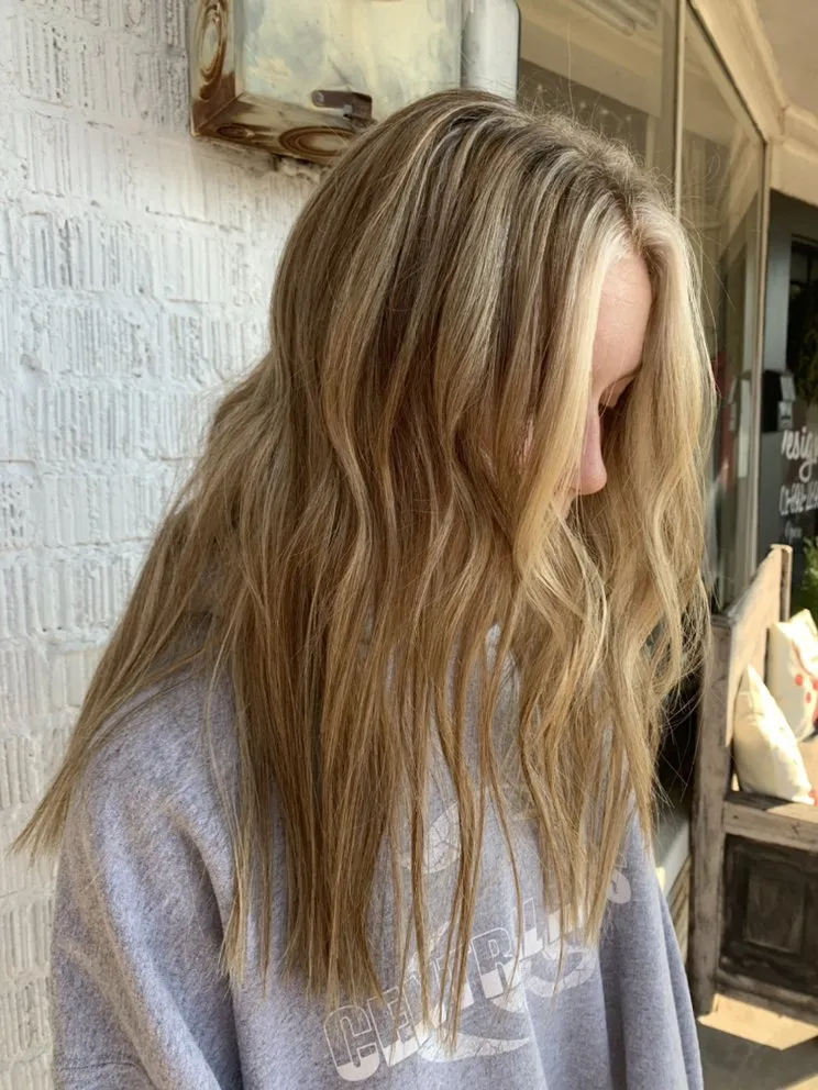 Wavy bronde color outside the white-brick storefront of Halo Salon in Crystal Springs, MS